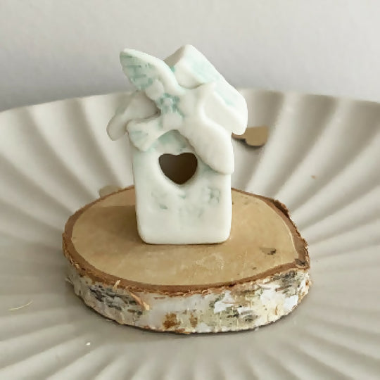 A Mini House With A Wooden Base