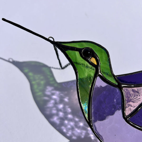 Green and purple stained glass hummingbird - maximalist style