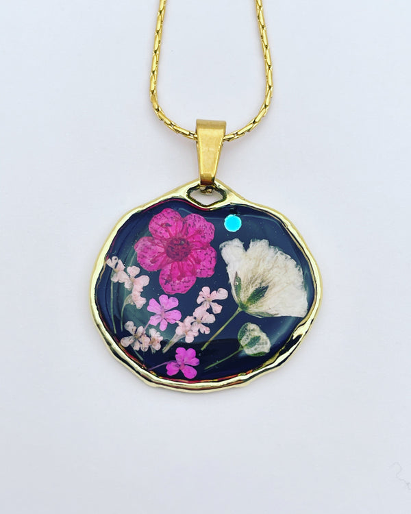 Black pendant necklace with pink and white flowers