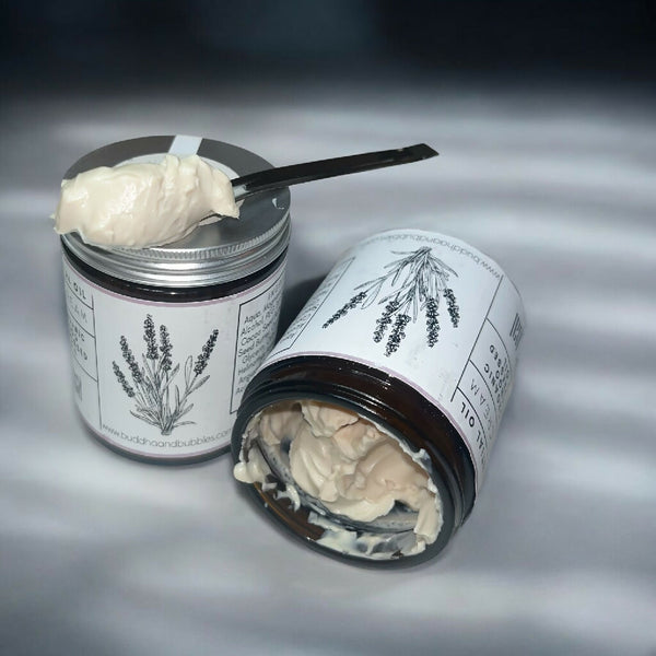 magnesium sleep cream on a metal spoon with jars in background showing the consistency
