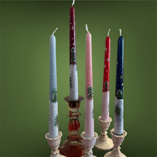 Hand painted candles with a festive snow scene