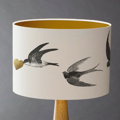 Handcrafted swallow lampshade featuring vintage flying bird illustrations and British countryside design