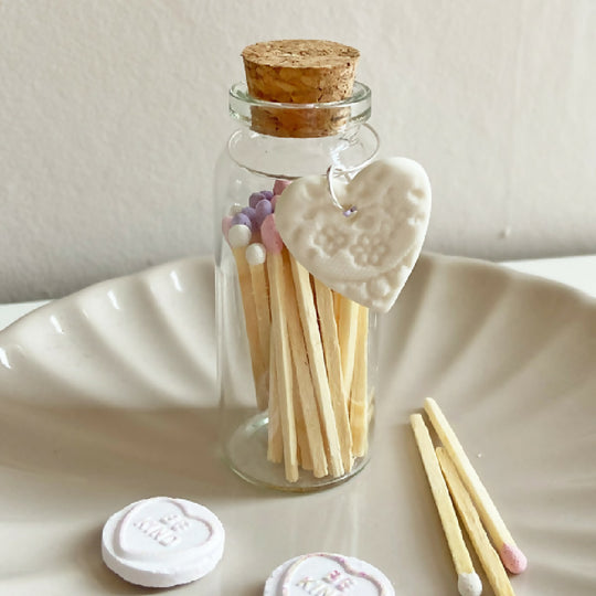 A Bottle Of Love Heart Matches And Porcelain Heart Charm
