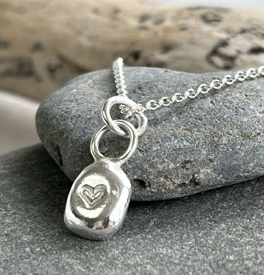 A recycled silver heart stamped pendant necklace