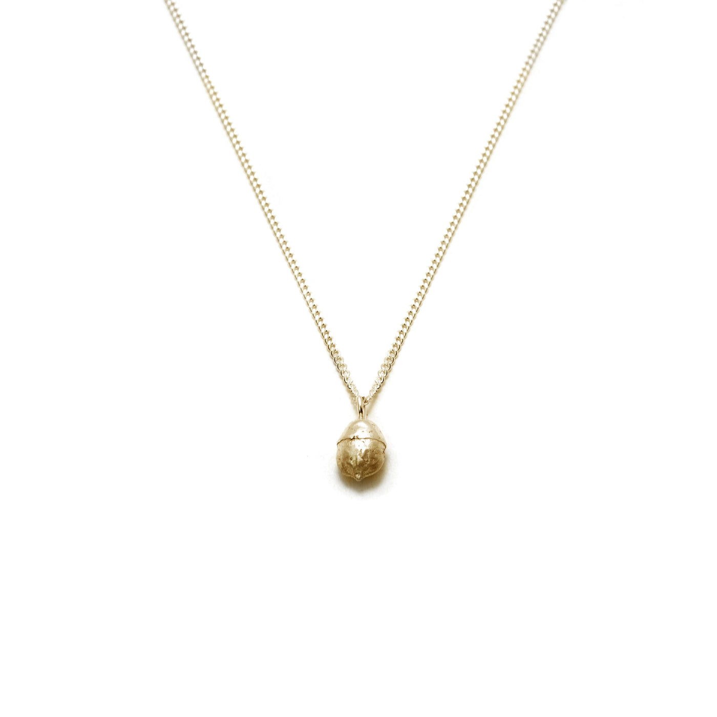 gold yew berry necklace on white background