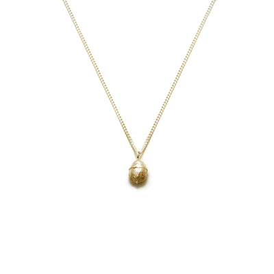 gold yew berry necklace on white background