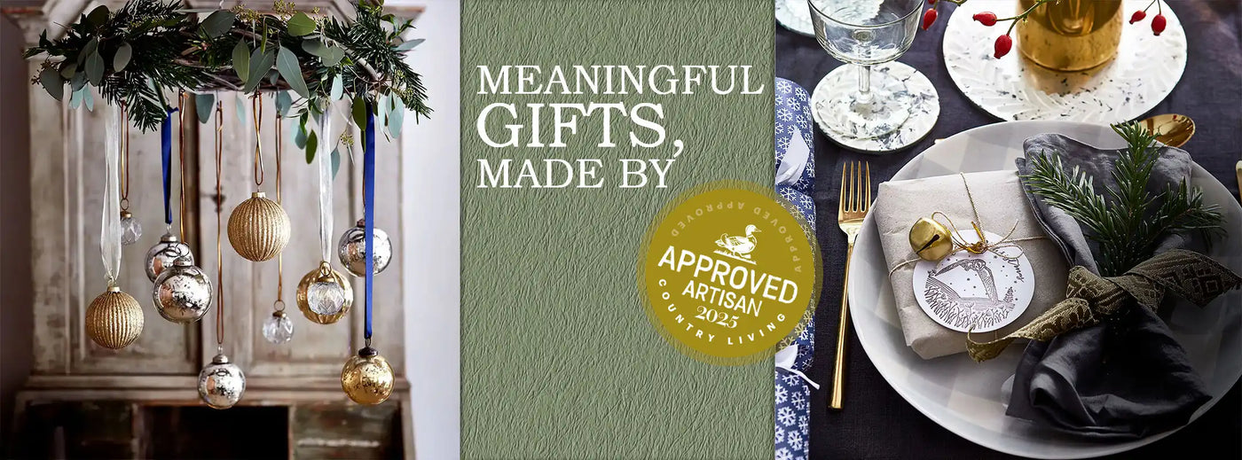 Decorative table setting with gold ornaments and a 'Meaningful Gifts, Made by' book in the center.