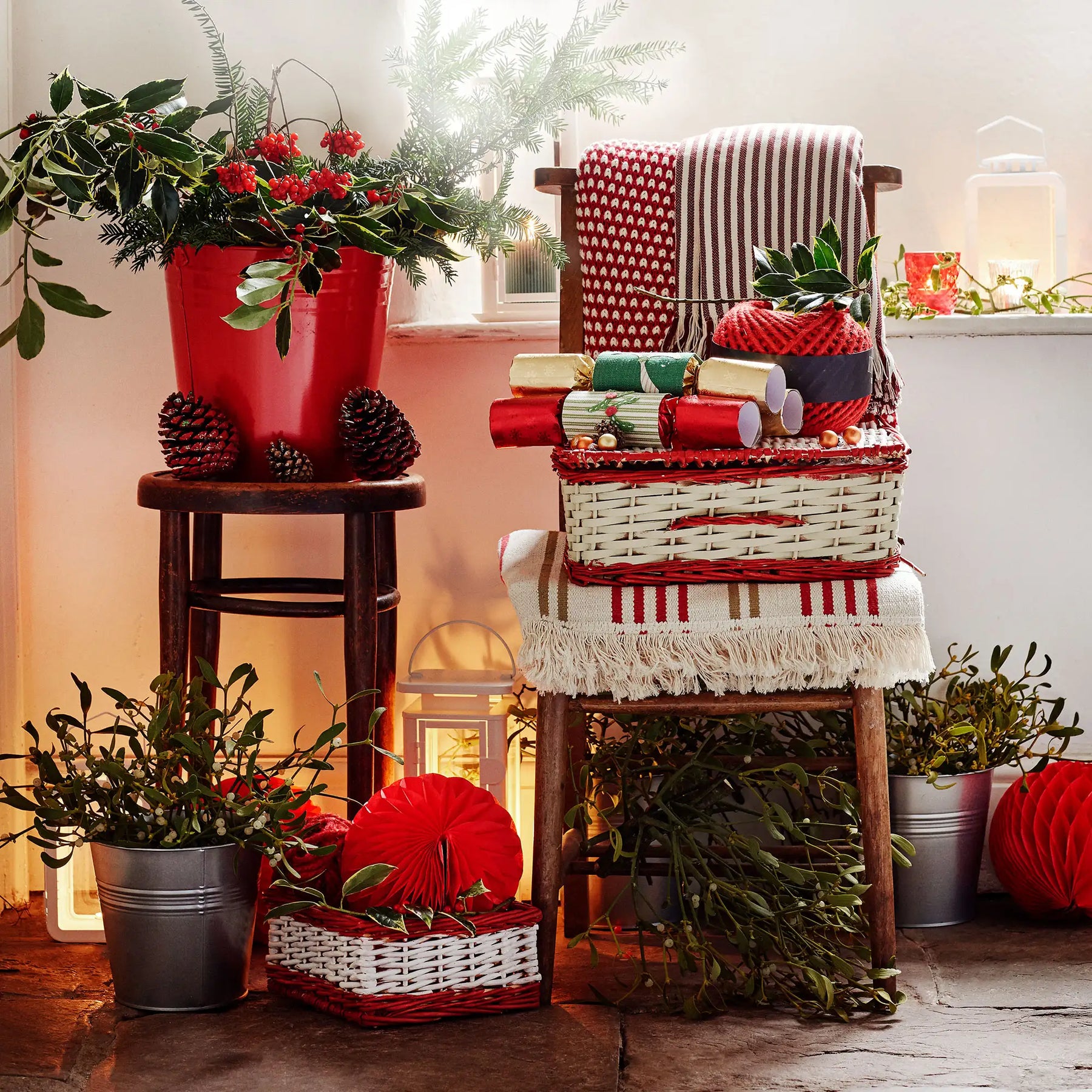 Decorative Christmas scene with a chair, plants, and gift boxes in a home setting.