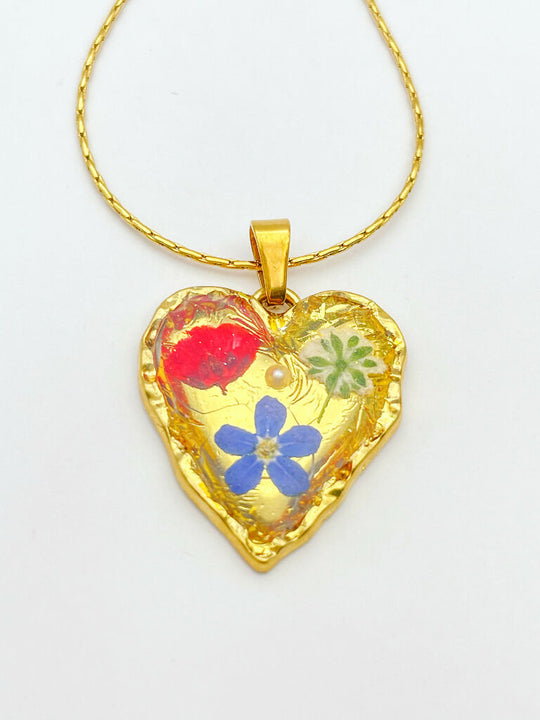 Heart necklace with forget-me-not and poppy flowers