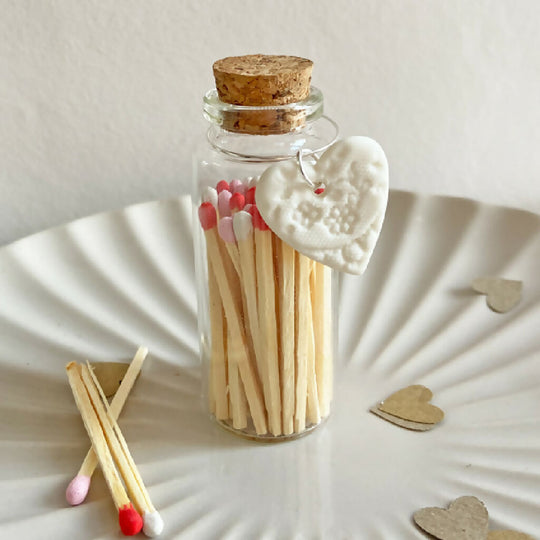 A Bottle Of Mixed Matches And Porcelain Charm