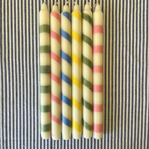 Handpainted ivory candles featuring playful stripes and twists