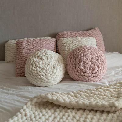 cream & pink round hand-knit cushions