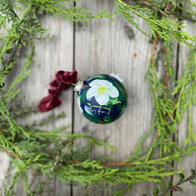 Hand-painted ceramic floral Christmas tree bauble with a deep blue background and white hellebore flowers. Shop more hand-painted Christmas decorations by Kate Godley-Harrod on the Country Living Marketplace.