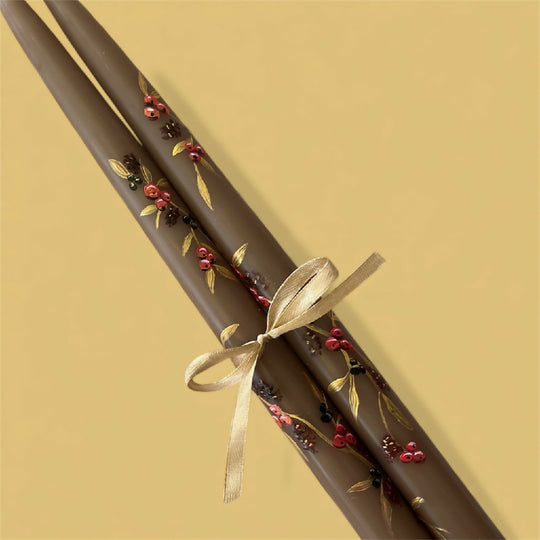 Hand painted pair of tapered brown candles with a berry design priced per pair