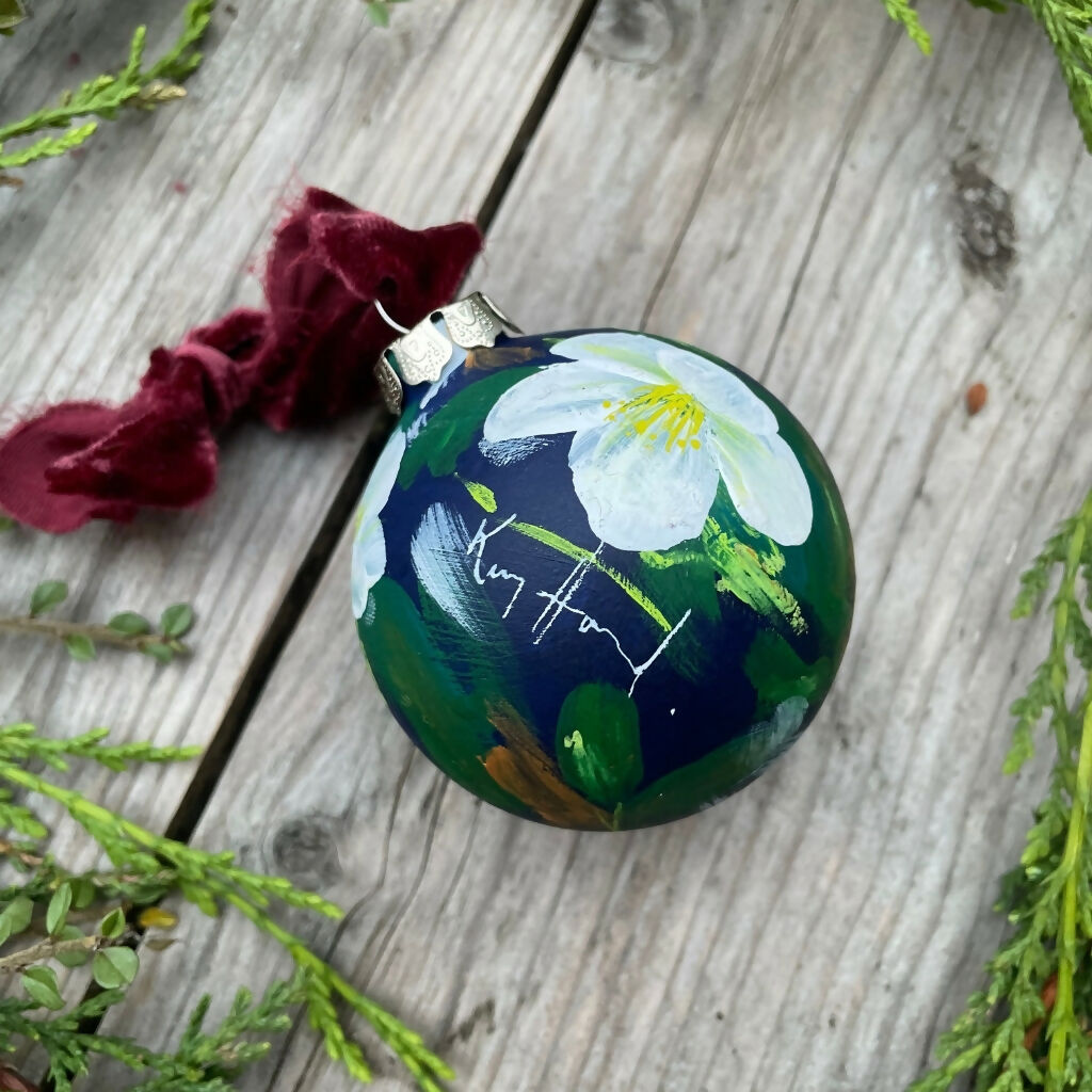 Hand-painted ceramic floral Christmas tree bauble with a deep blue background and white hellebore flowers. Shop more hand-painted Christmas decorations by Kate Godley-Harrod on the Country Living Marketplace.