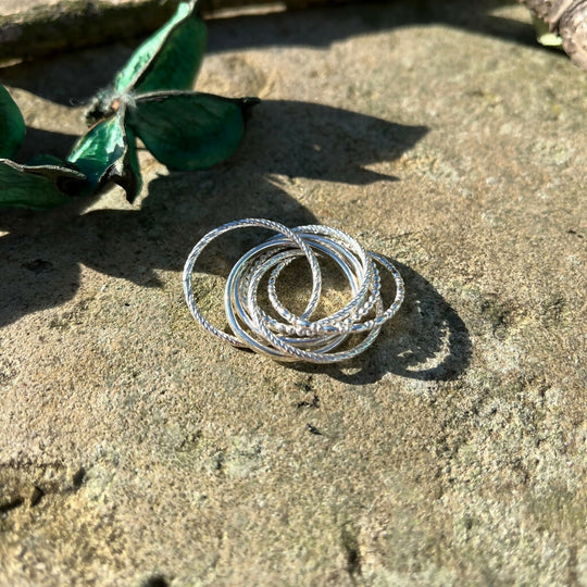 Sterling silver crossover interlocking rolling ring with textured bands