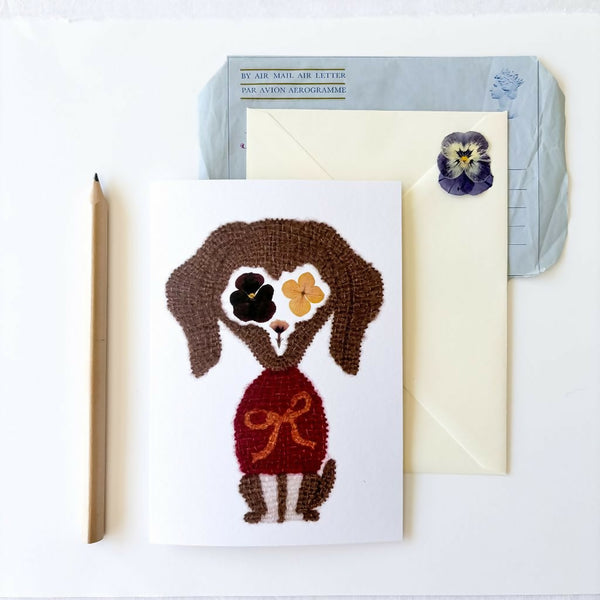Botanical Dachshund greetings card featuring artwork originally hand embroidered with silk and alpaca yarn onto pressed flower watercolour paper. Blank inside with an envelope.