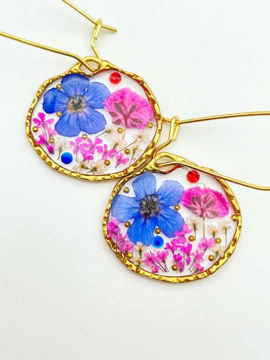 Dangling earrings with real pink and blue flower