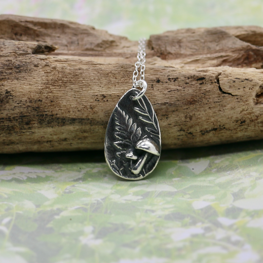 Silver fern and mushroom pendant