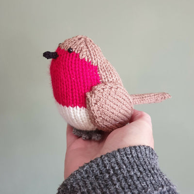 knitted robin in hand