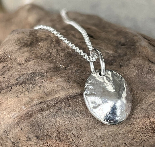 A hand cast fine silver limpet shell necklace