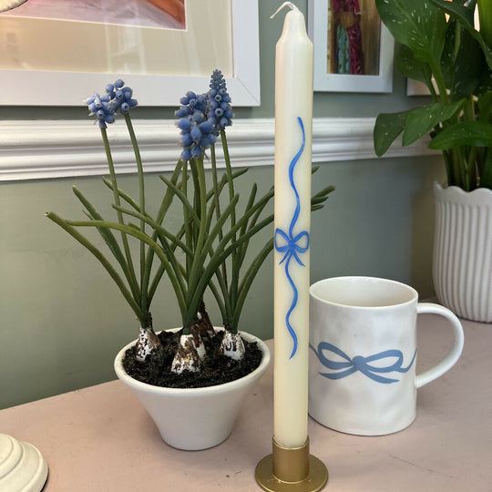 Hand painted ivory candles in a delicate bow design