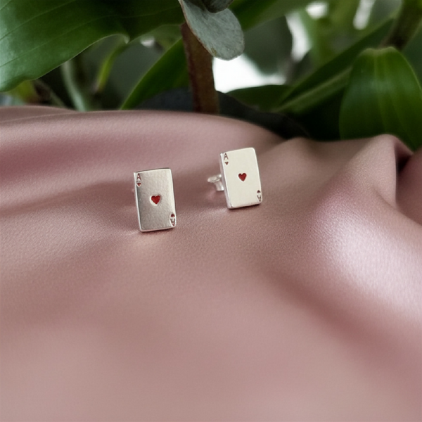 Sterling silver ace of hearts studs on dusky pink satin
