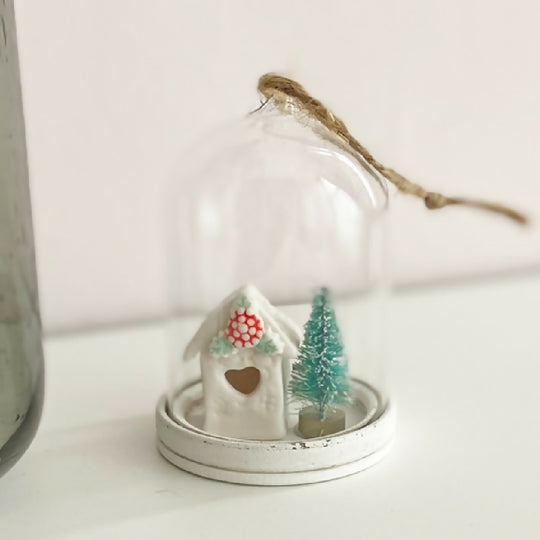 A Glass Dome With Holly House Decoration
