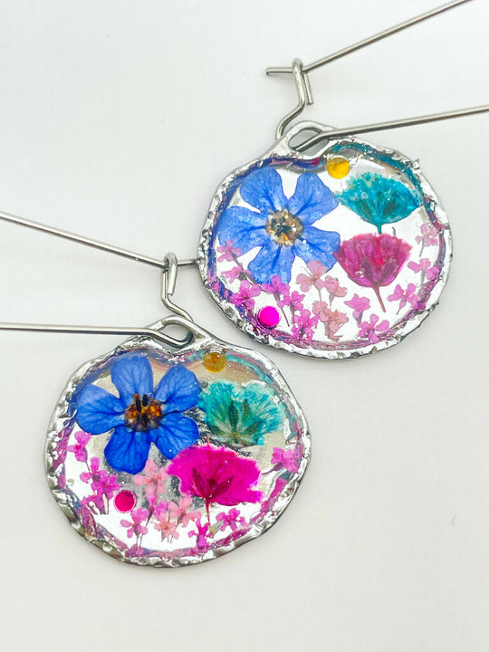Silver dangle earrings with pink and blue flowers
