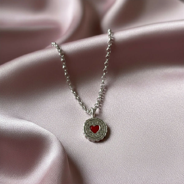 Silver jammy digger necklace with red hearts in the centre