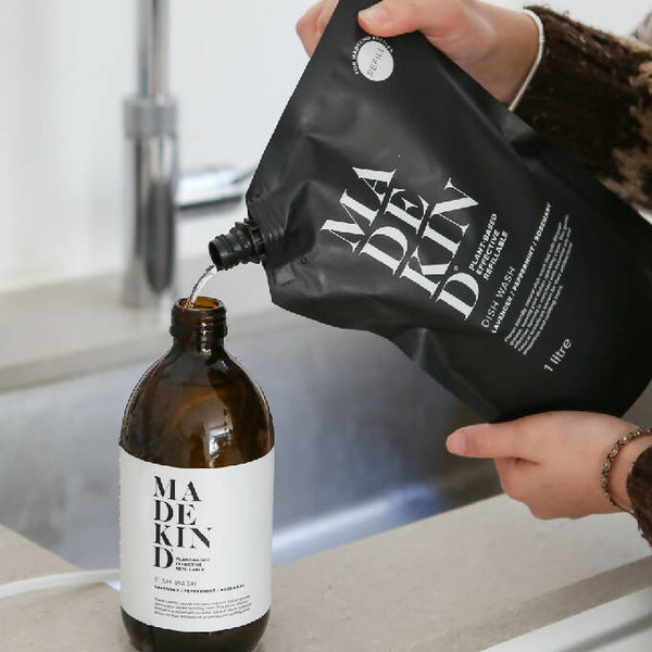 1 litre Dish Wash Pouch being poured into an empty bottle