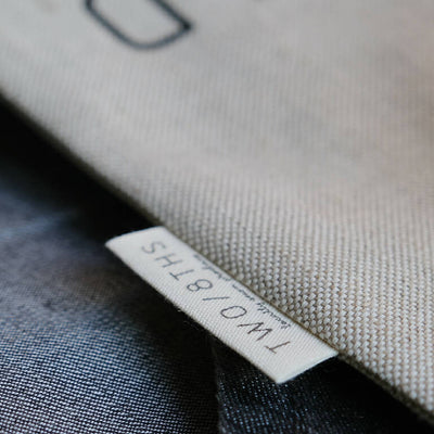 The makers tag sewn on a linen produce bag.