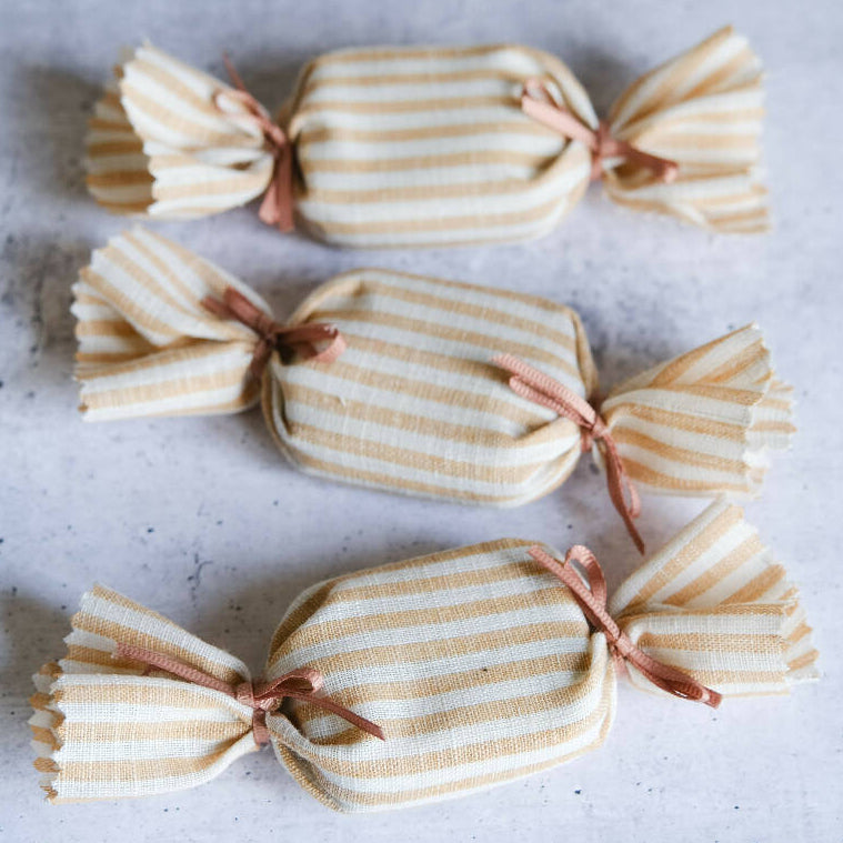 Beige and white stripey fabric humbugs for treats and favours