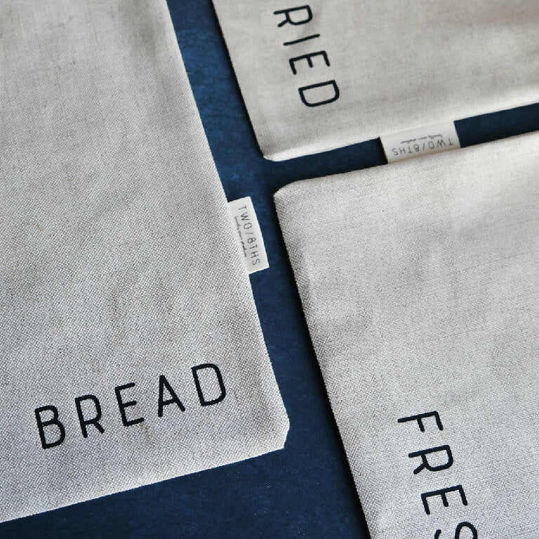 Set of three linen produce bags for bread, dried goods, and fresh food.