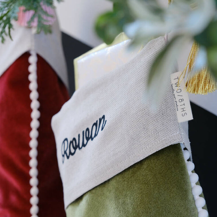 a close up of the personalised linen cuff on a christmas stocking