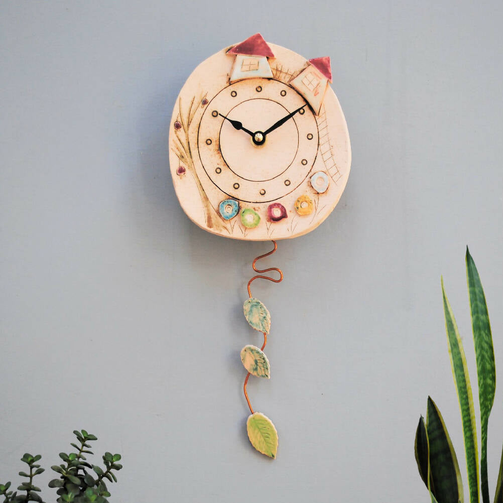 Round Ceramic Pendulum Wall Clock with Houses, Trees, and Meadows