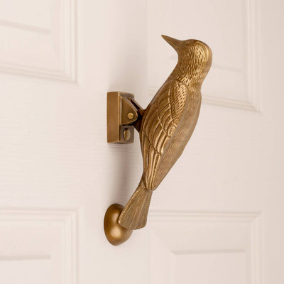 Cosima Woodpecker Door Knocker in Aged Brass