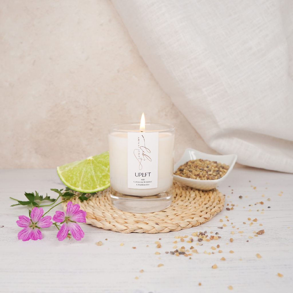 A soy candle styled with frankincense and geranium flowers.png