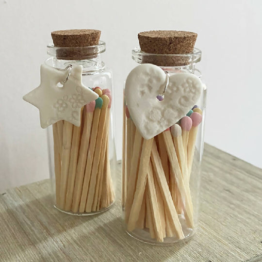A Bottle Of Pastel Matches And Porcelain Charm