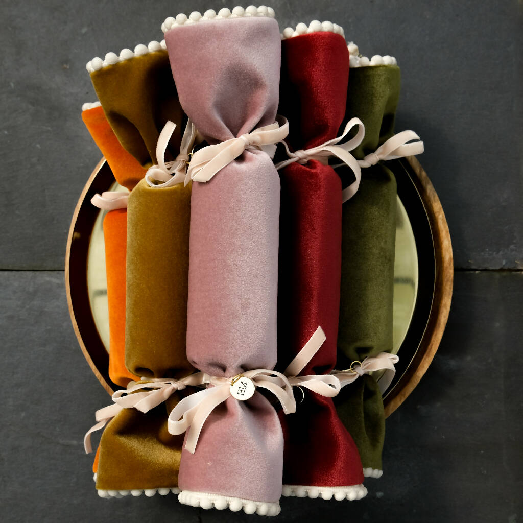 A collection of velvet reusable crackers with pompom trim