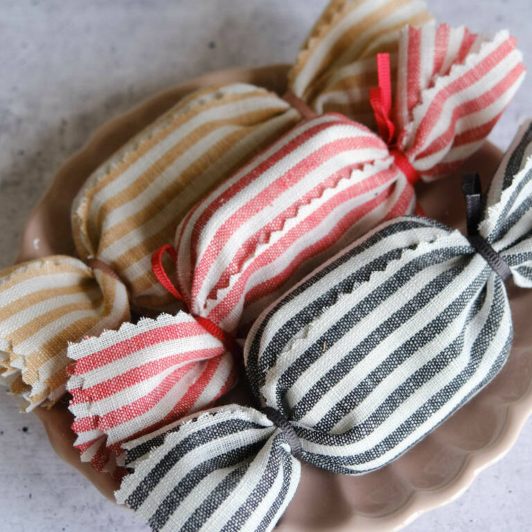 A set of three multi coloured striped fabric humbugs