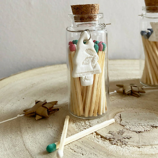 A Bottle Of Christmas Matches And Porcelain Charm