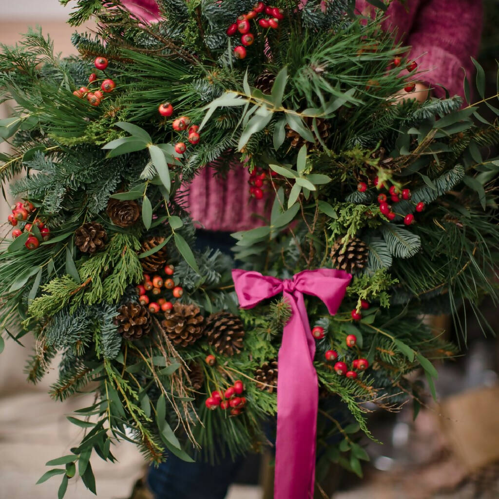 studioEVIG - Christmas wreath pink ribbon being held (1)
