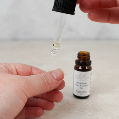 Applying a drop of nail oil to the nail and cutcle.jpg