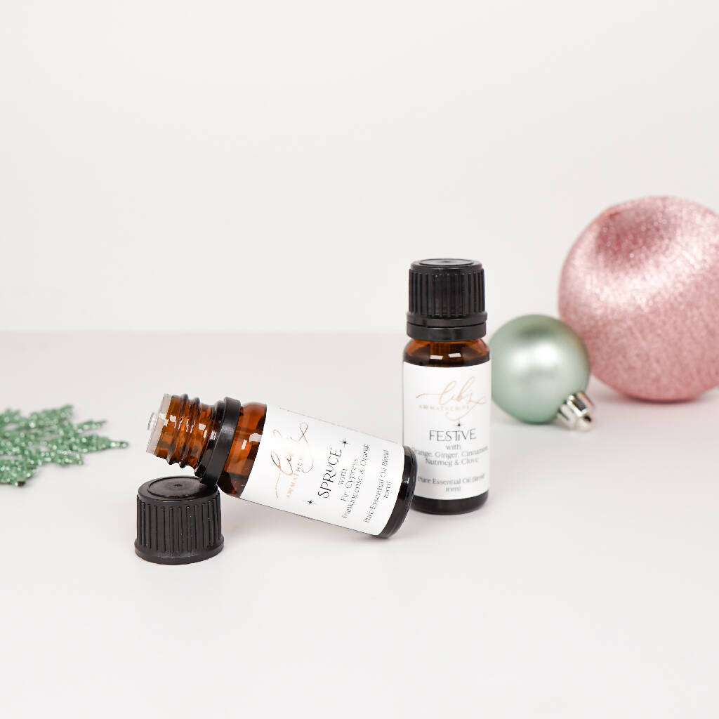 Two festive essential oil blends with christmas baubles