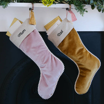 Christmas stockings personalised with Mum and Dad hung from the mantelpiece