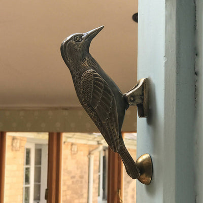 Cosima Woodpecker Door Knocker in Aged Brass